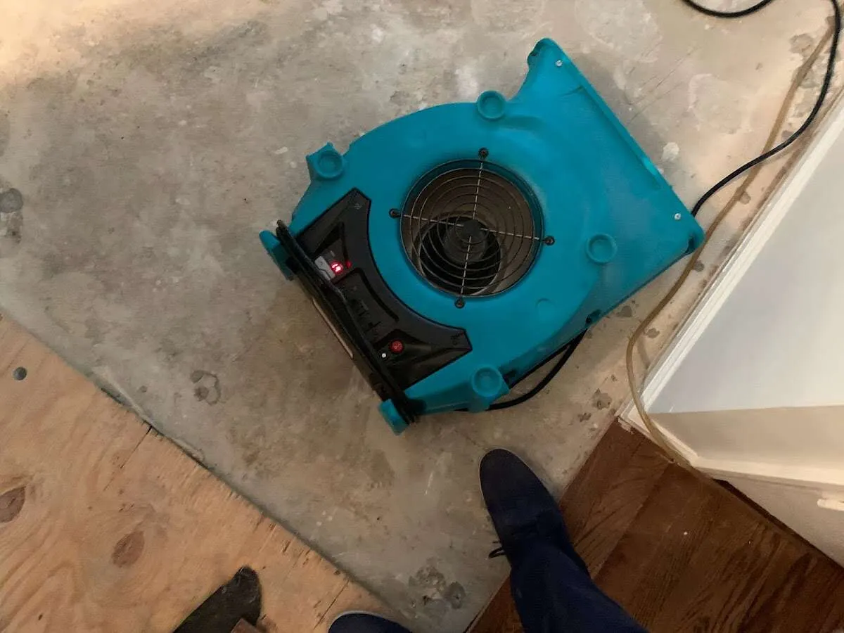 Air mover drying subfloor during Commercial Water Damage Restoration in Hartford