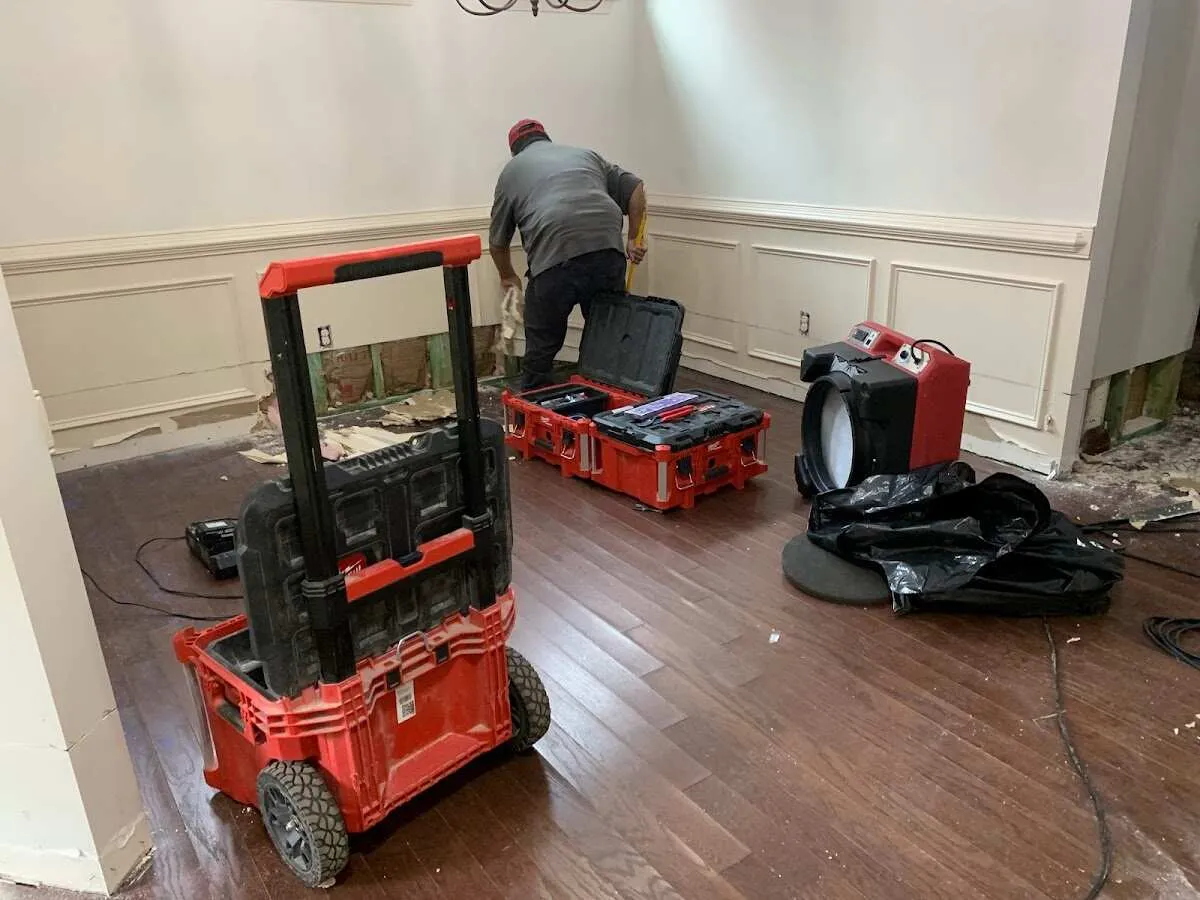Technician setting up drying equipment for water damage in Hartford